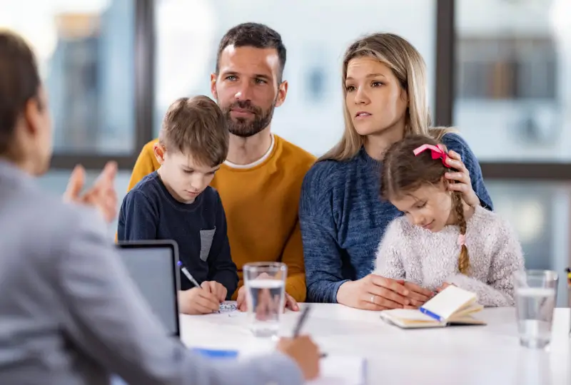 Home 6 Family sitting together with a mediator during a family mediation session in Canberra